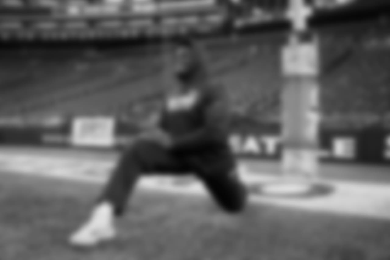 Tackle Germain Ifedi stretches on the field, which was decorated for the annual "Salute to Service" game.