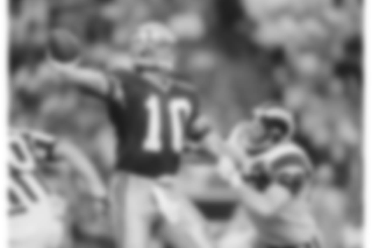 Quarterback Dan McGwire (10) of the Seattle Seahawks manages to get the pass off in time to avoid the sack as Jim Skow (68) of the Los Angeles Rams applies the defensive rush during the fourth quarter of their pre-season NFL game, Aug. 7, 1992, in Seattle. Los Angeles beat Seattle, 21-7. (AP Photo/Bill Chan)