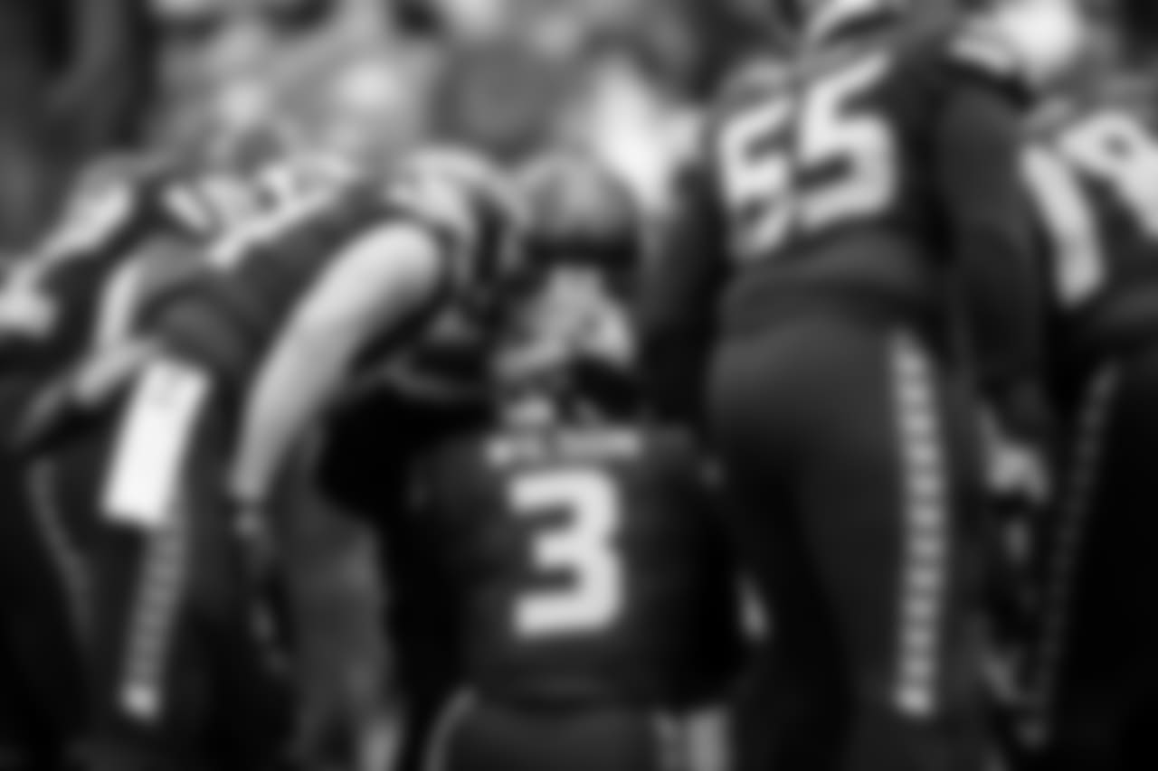 Seahawks quarterback Russell Wilson huddles the offense in the first half.