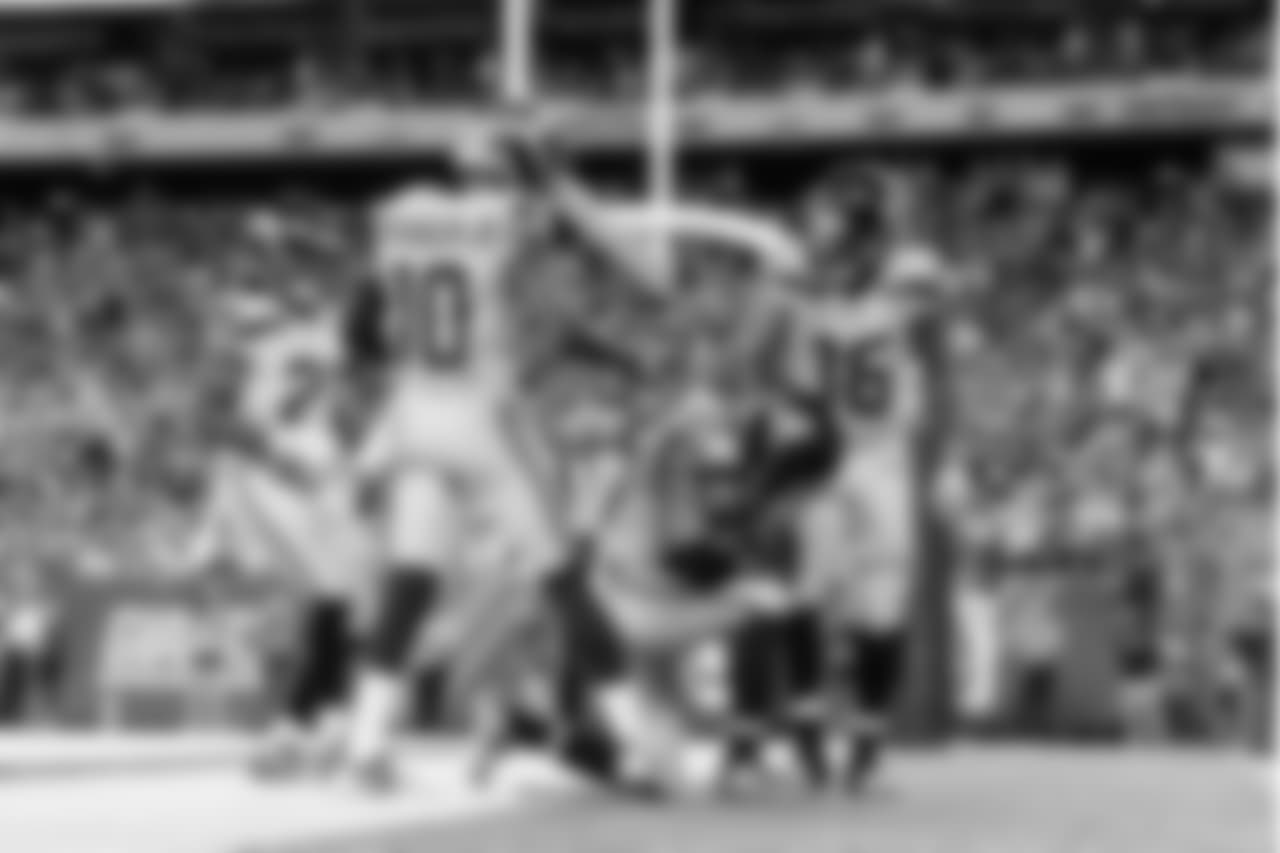 Doug Baldwin kneels after his touchdown surrounded by teammates Paul Richardson, J.D. McKissic and Tyler Lockett.