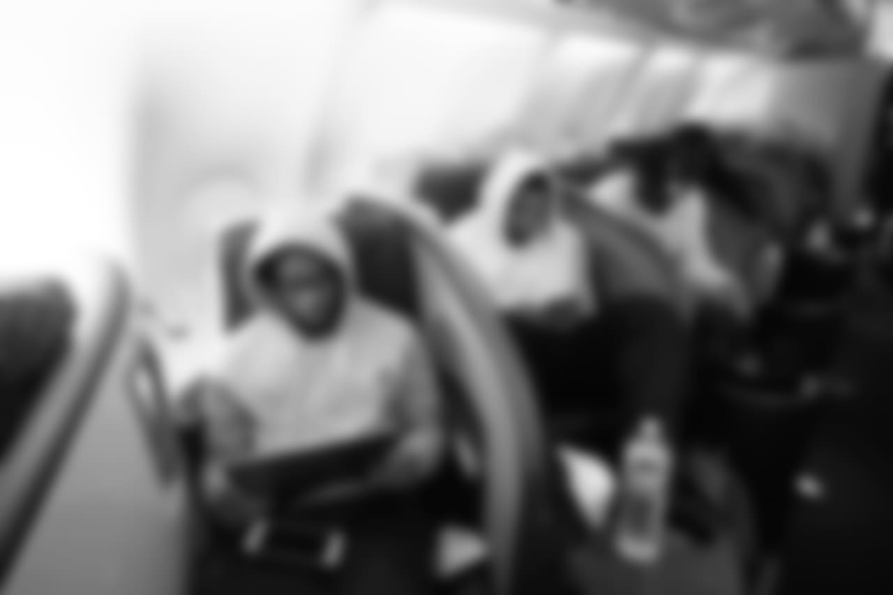 Safety Tedric Thompson studies tape on the flight to London.