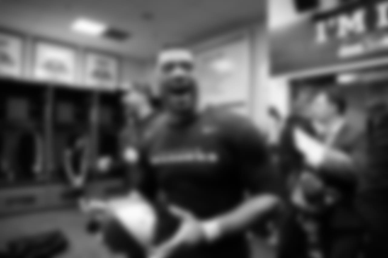 A jubilant Seahawks quarterback Russell Wilson enters the victorious locker room after the game.