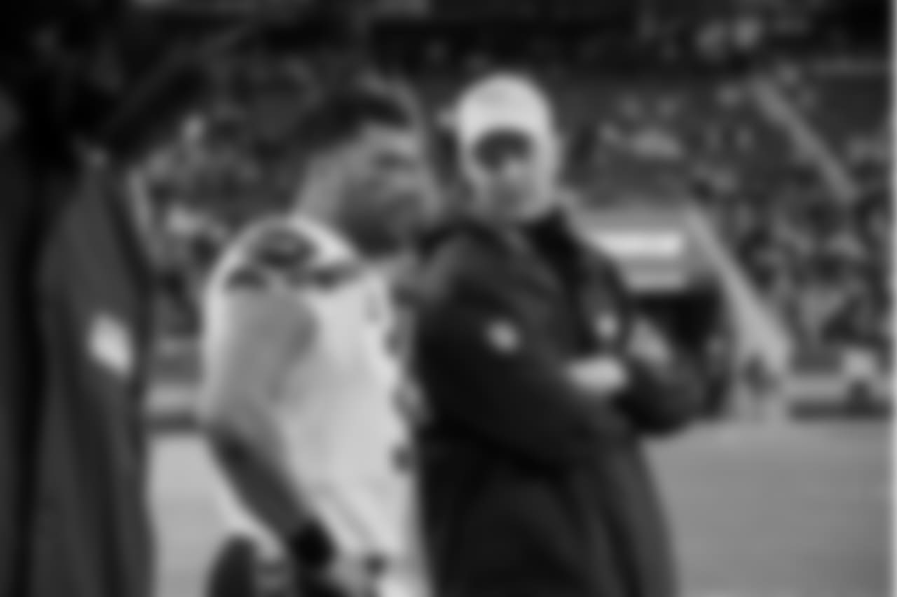 Near the end of the game, offensive coordinator and quarterback Russell Wilson chat on the sidelines.