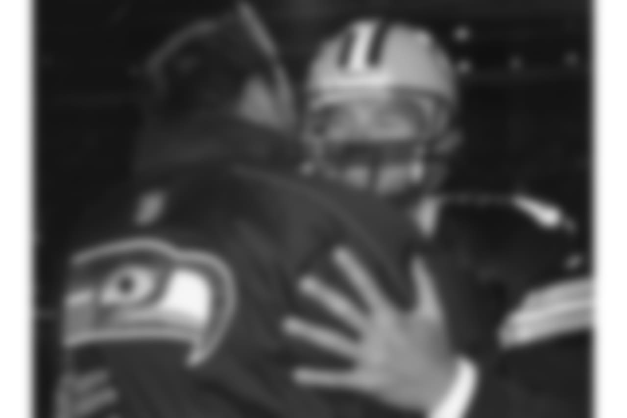 Green Bay Packers quarterback Brett Favre hugs his former head coach (and current coach of the Seattle Seahawks) Mike Holmgren before a 27-7 Seahawks victrory on November 1, 1999, at Lambeau Field in Green Bay, Wisconsin. Holmgren had left Green Bay following the 1998 season and was in his first season as coach of the Seahawks. (AP Photo/Vernon Biever)