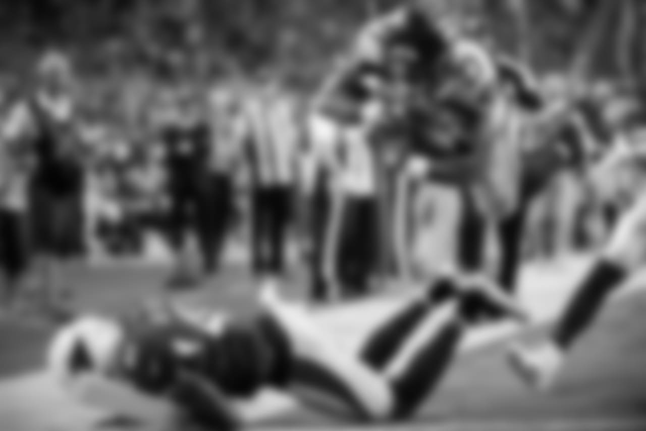 Running back Mike Davis dives into the end zone with Seattle's first touchdown after barreling through Arizona defender Antoine Bethea.