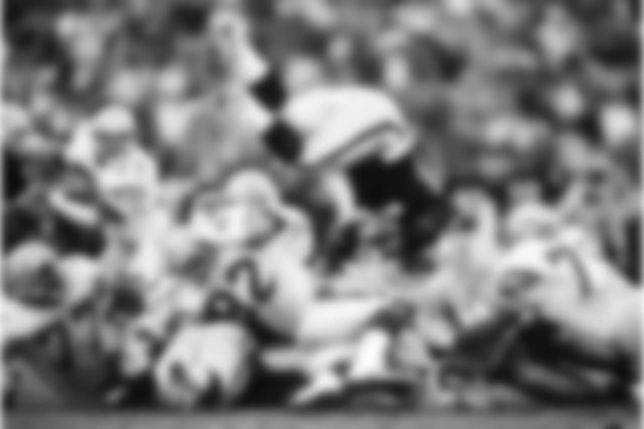 Seattle Seahawks defensive lineman Dave Wyman (92) flips Los Angeles Raiders running back Marcus Allen (32) in the air during the NFL football game against the Los Angeles Raiders on Dec. 18, 1988 in Los Angeles. The Seahawks won the game 43-37. (Paul Spinelli via AP)