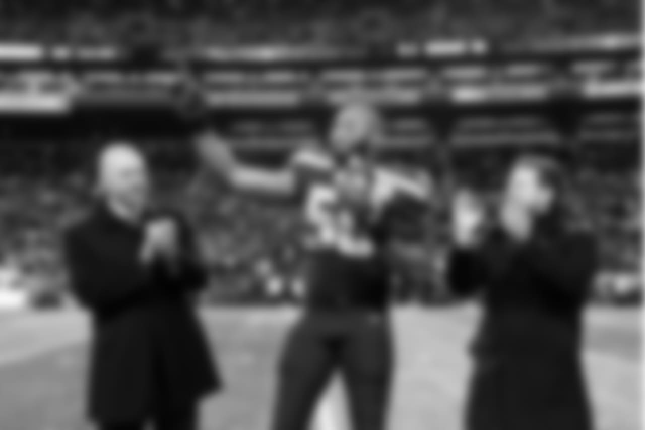 Seahawks linebacker K.J. Wright, flanked by team president Chuck Arnold (left) and general manager John Schneider, is awarded the Seahawks Man of the Year award during pregame.