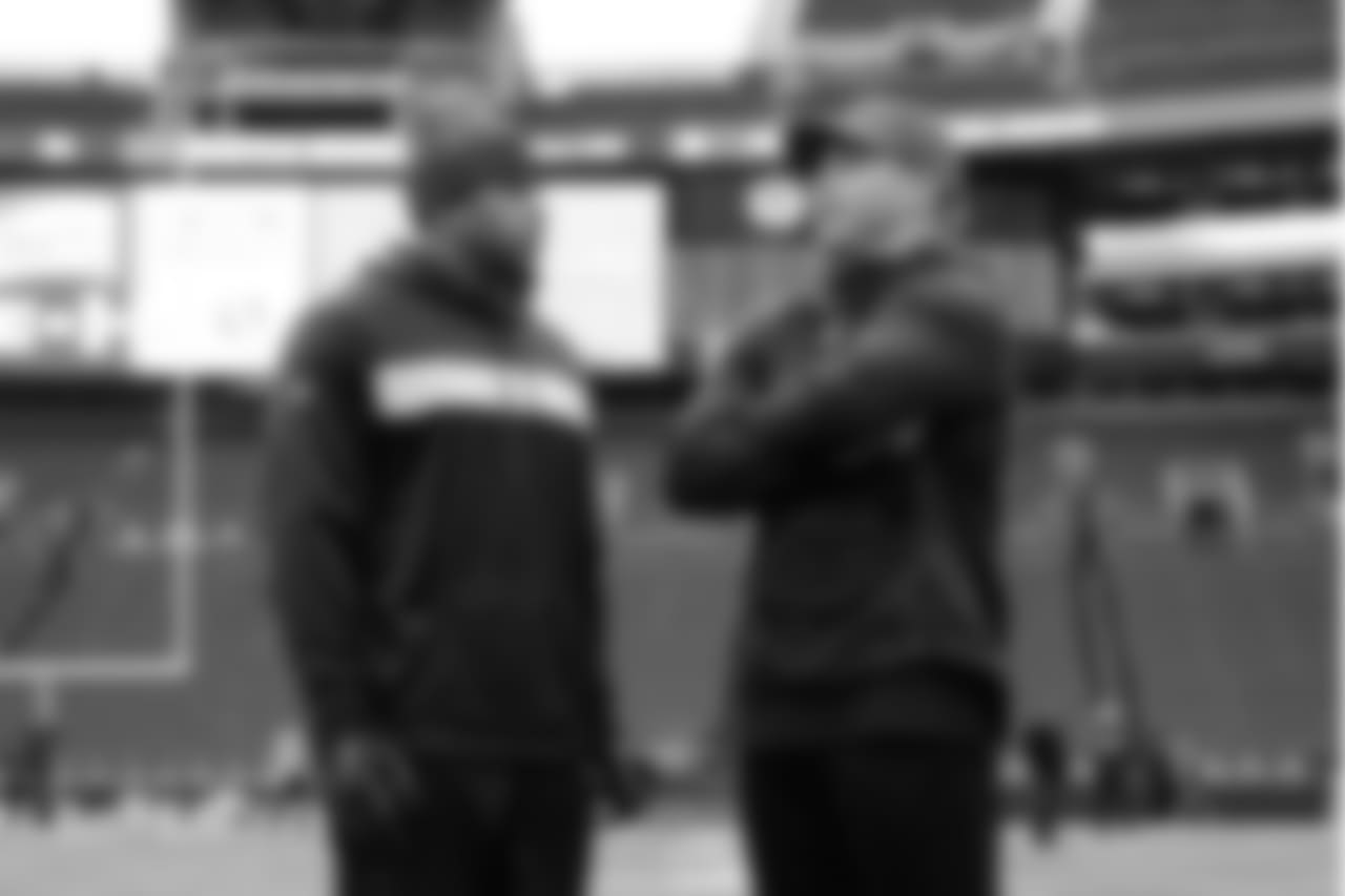 Seahawks linebacker Bobby Wagner talks with former teammate Brock Coyle on the field during early pregame warmups.