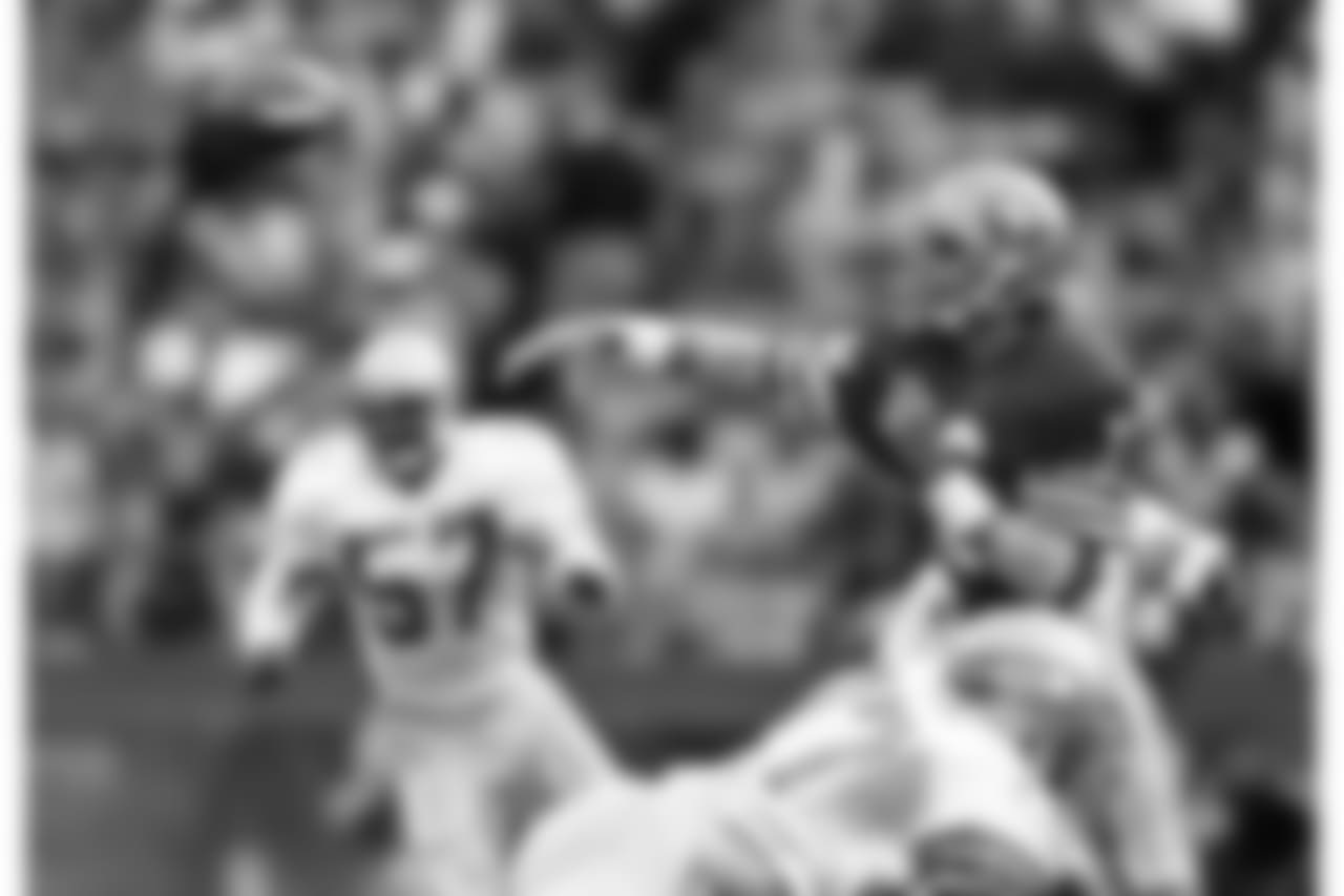 San Francisco quarterback Joe Montana (16) passes during an NFL football game against Seattle Seahawks on Sunday, Nov. 25, 1985, in San Francisco. The 49ers won the game, 19-6. (AP Photo/Greg Trott)