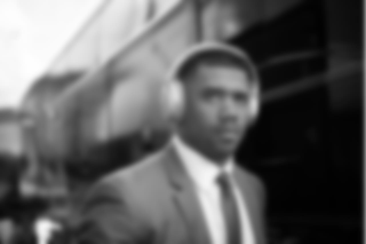 On Sunday, Russell Wilson was sharp in a suit and tie with Bose headphones as he boarded the bus from the team hotel to the stadium.