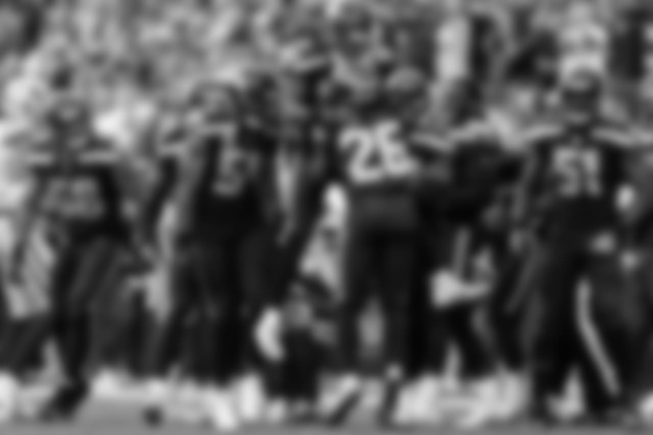 Shaquem Griffin (in air) celebrates with his brother Shaquill Griffin and Seahawks teammates after a special teams tackle.