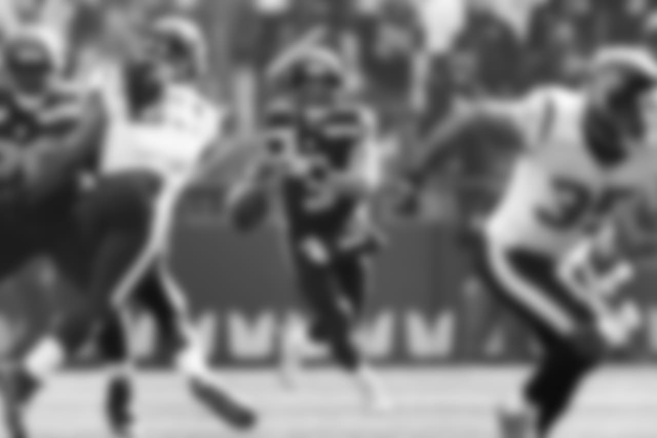 Russell Wilson, who had a career day on Sunday, looks downfield while on the run in the second quarter.