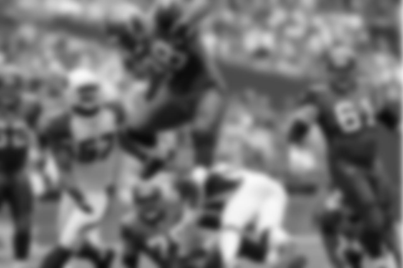 **RAW FILE**Seattle Seahawks' Mack Strong (38) leaps over a defender on a first quarter, 14 yard run as Arizona Cardinals' Orlando Huff (57) moves in, Sunday, Sept. 17, 2006, in Seattle. The Seahawks won 21-10. (AP Photo/Elaine Thompson)
