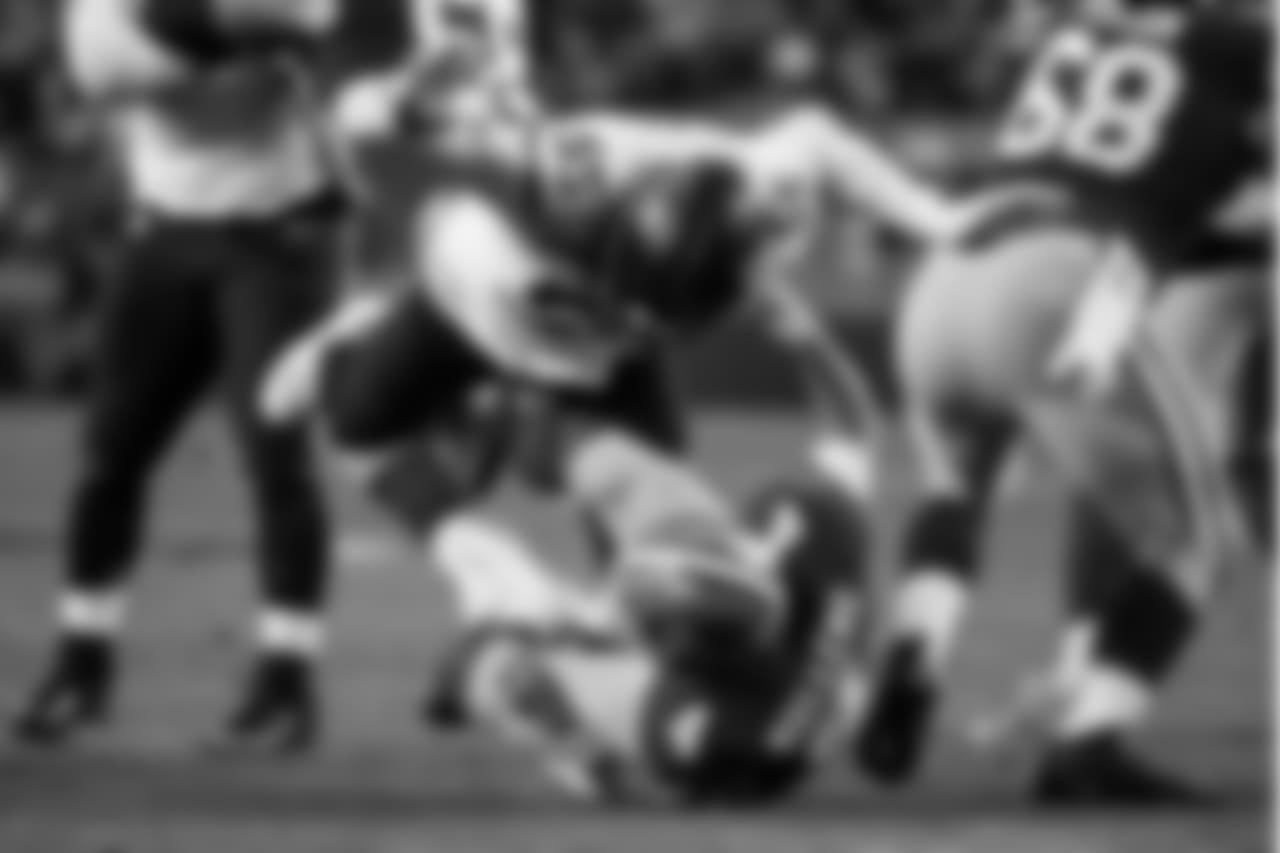 Seattle's Frank Clark keeps his hands away from Nick Mullen as they fall to the ground.