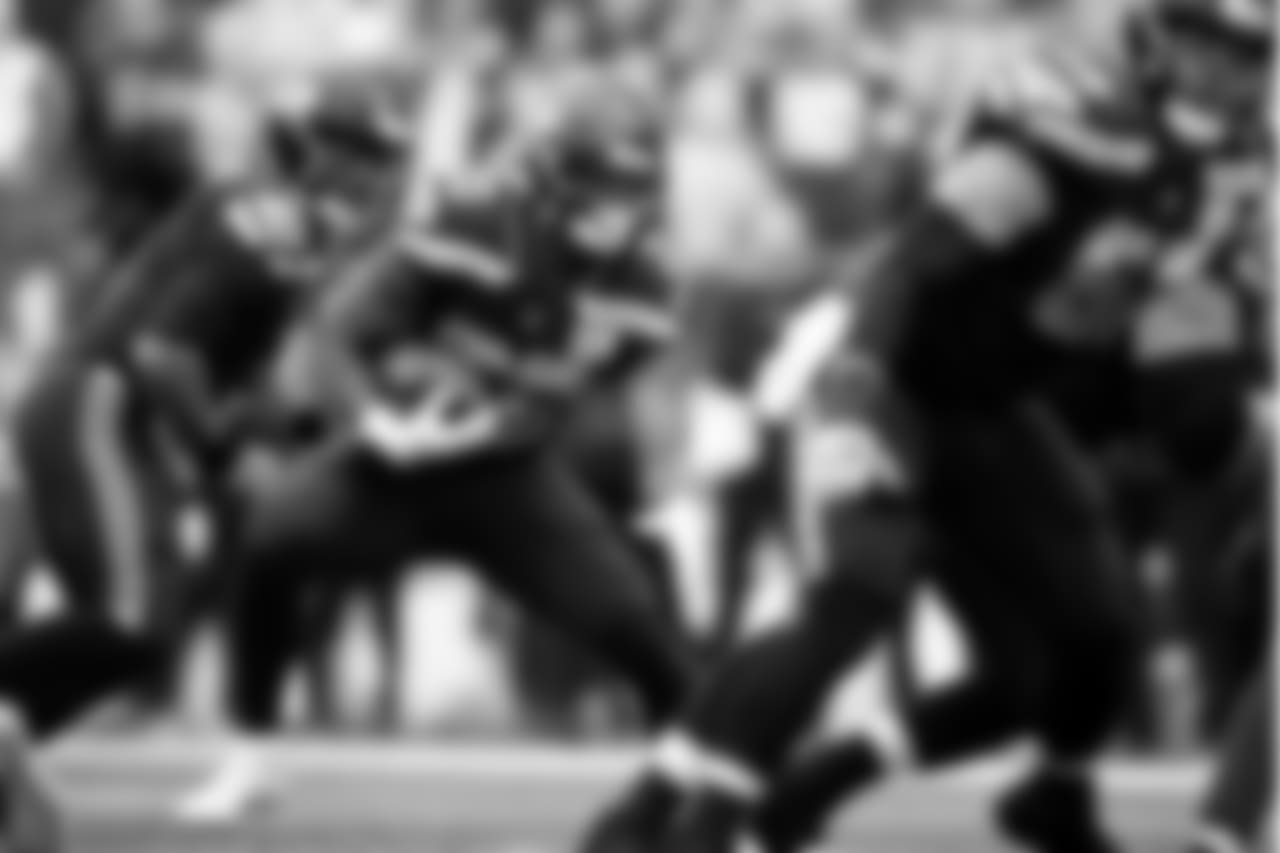 Seattle's Rashaad Penny looks for room behind the block of center Justin Britt.
