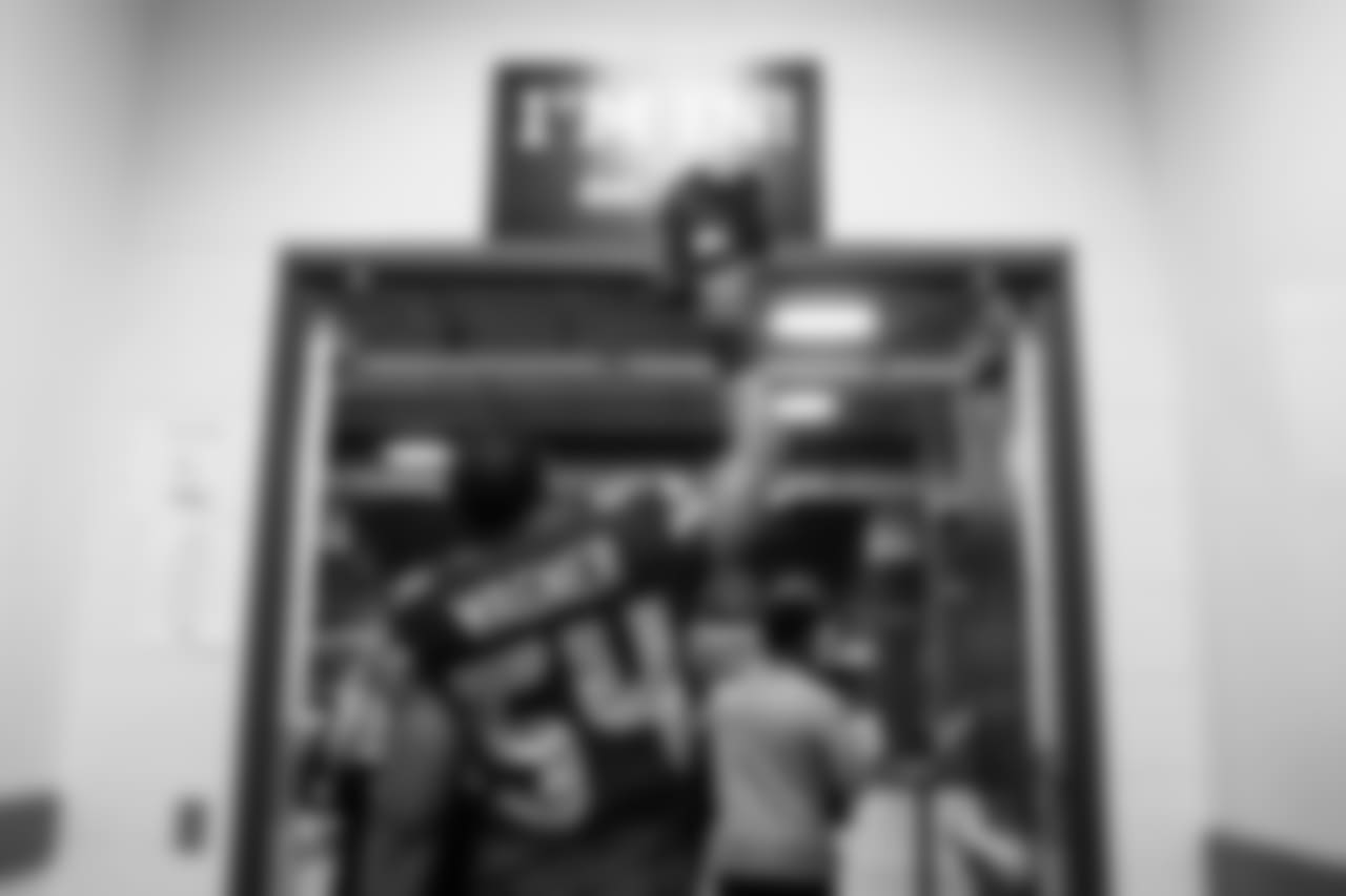 Linebacker Bobby Wagner "taps in" as he leaves the locker room for the field.
