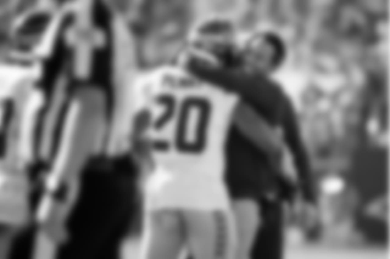 Seahawks running back Rashaad Penny receives congratulations from running backs coach Chad Morton after Penny's first career touchdown.