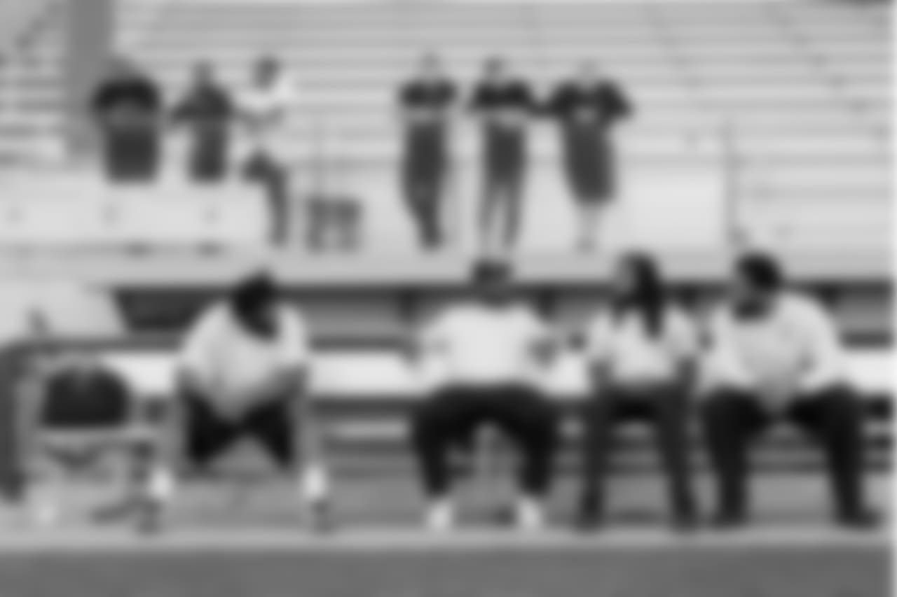 While the offense runs through plays, members of the defense including Sheldon Richardson, Cliff Avril, Richard Sherman and Michael Bennett sit on a nearby bench waiting their for their turn.