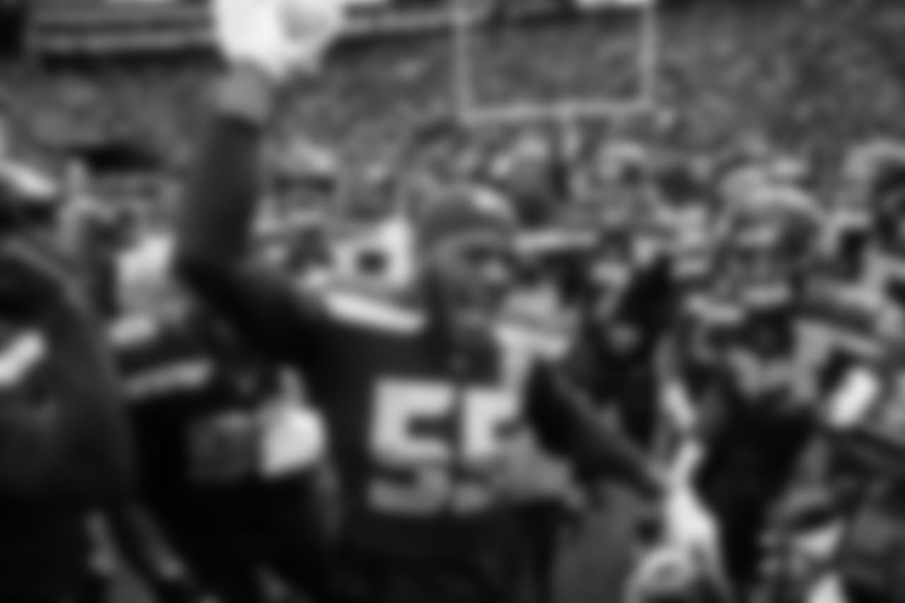 Frank Clark rallies his teammates as they take the field for pregame warmups.