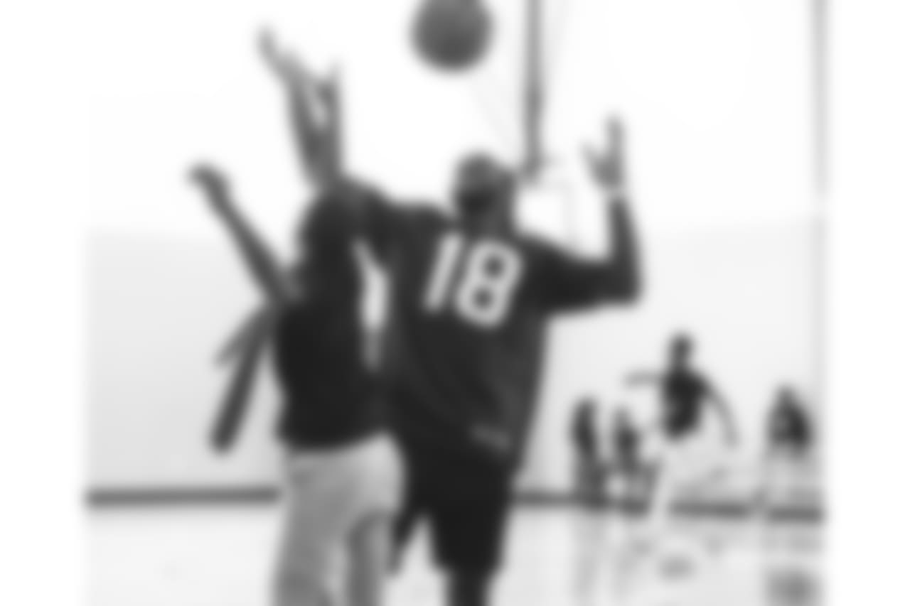 An image from the Sept. 25, 2018 community development event in which Sammie Coates Jr. and Julien Davenport played basketball and ate pizza with local students.