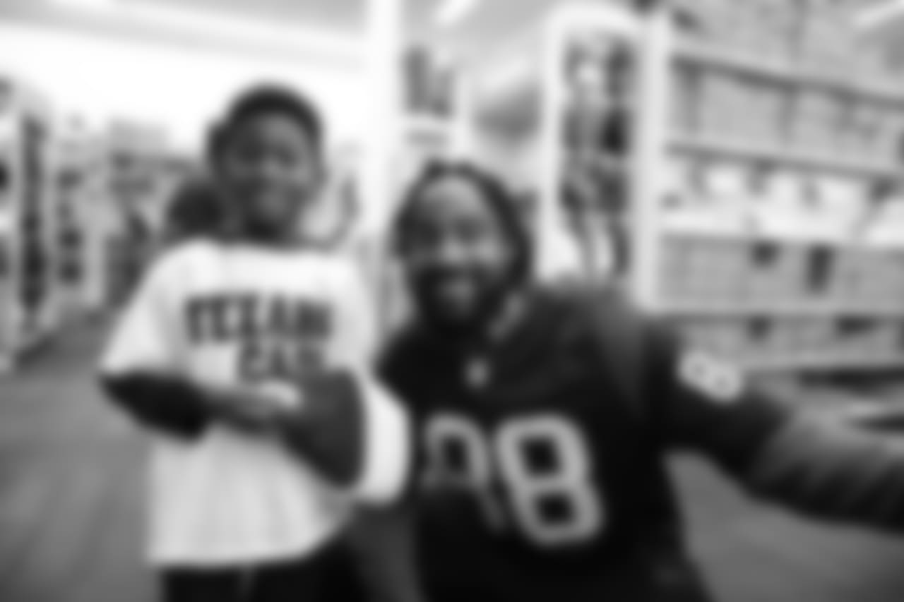 An image from a Dec. 18, 2018 community development event in which Texans rookie players shopped for Christmas gifts with Texans YMCA students.
