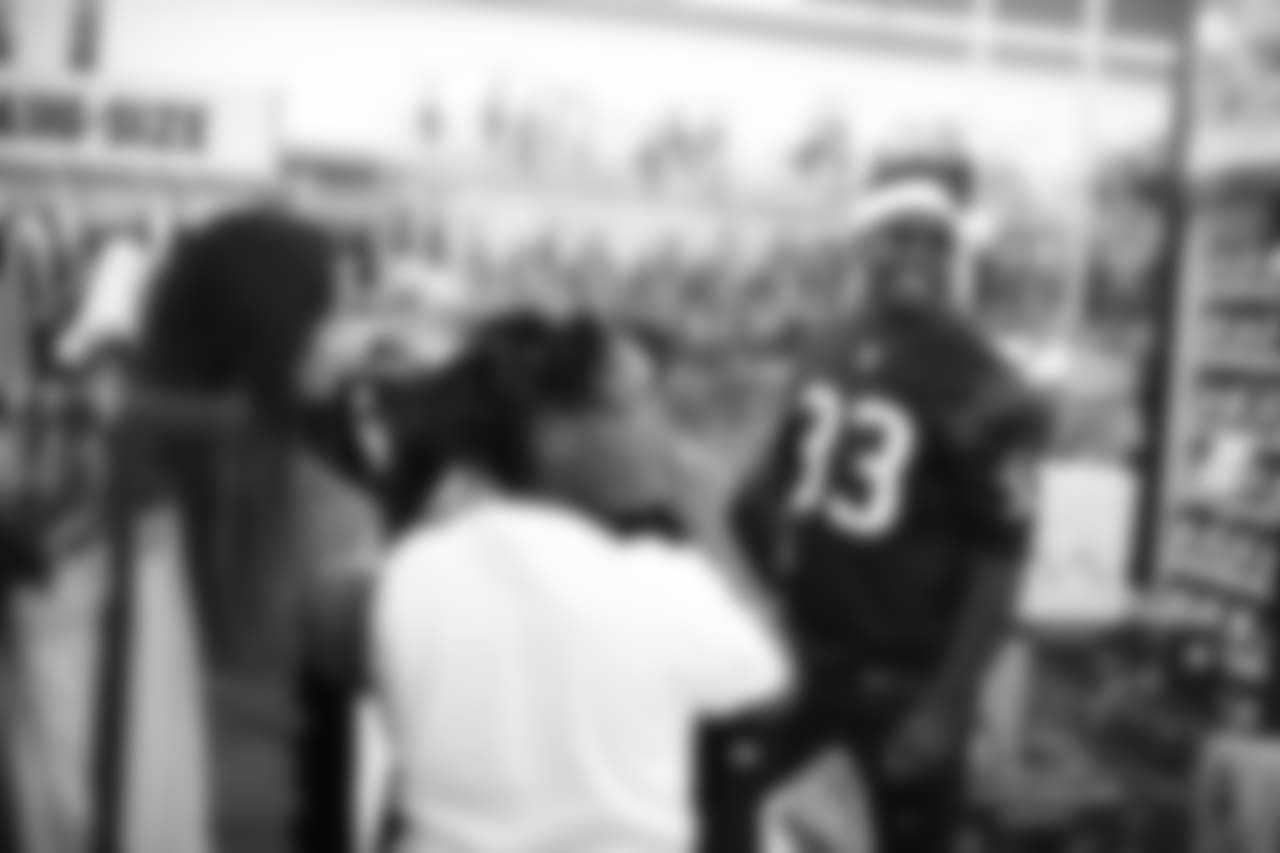 An image from a Dec. 18, 2018 community development event in which Texans rookie players shopped for Christmas gifts with Texans YMCA students.