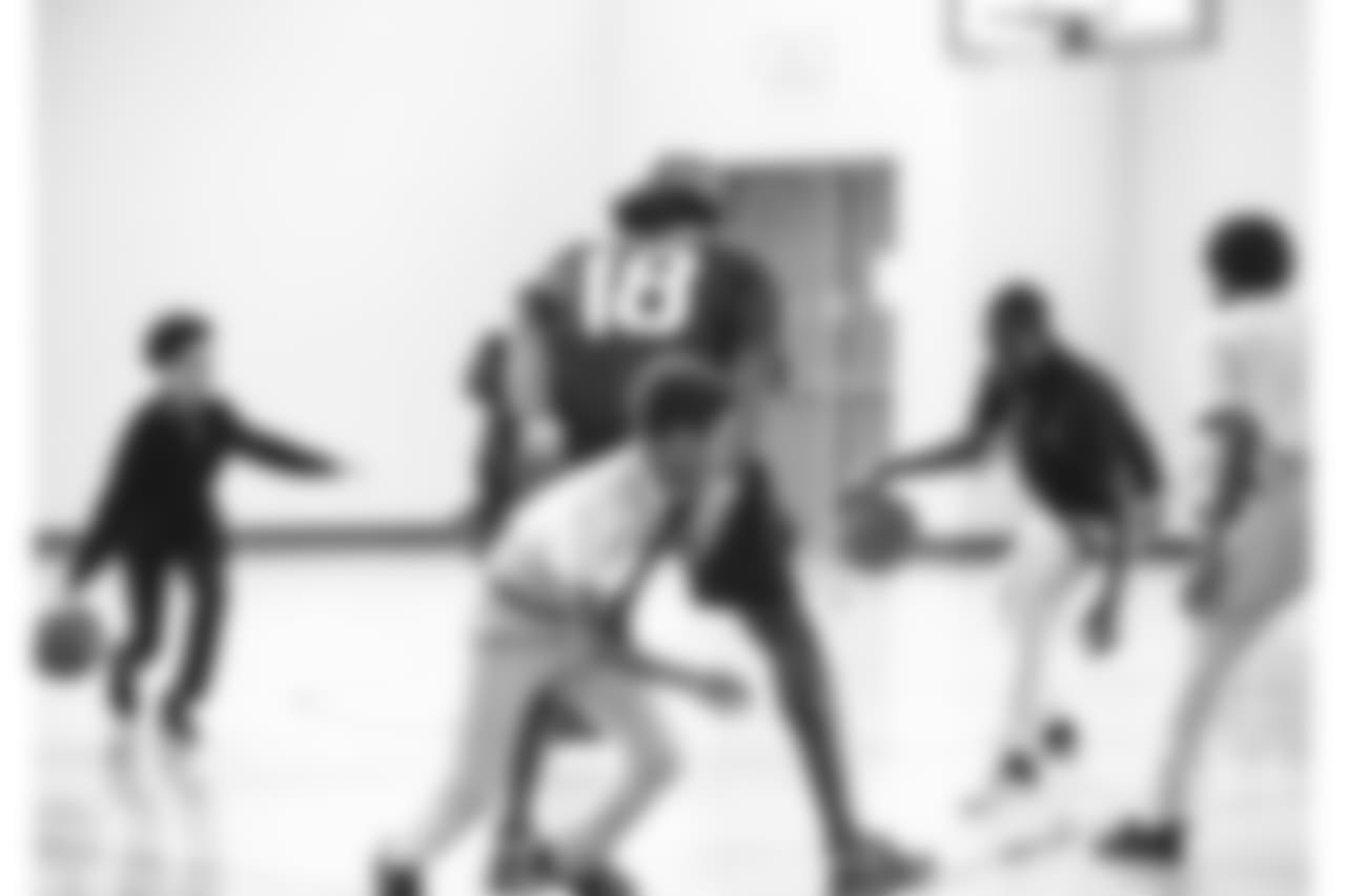 An image from the Sept. 25, 2018 community development event in which Sammie Coates Jr. and Julien Davenport played basketball and ate pizza with local students.