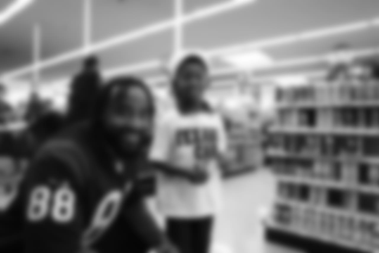 An image from a Dec. 18, 2018 community development event in which Texans rookie players shopped for Christmas gifts with Texans YMCA students.
