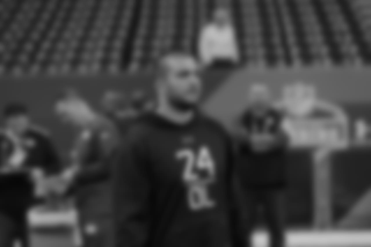 Oregon offensive lineman Hroniss Grasu watches players warm up at the NFL football scouting combine in Indianapolis, Friday, Feb. 20, 2015. (AP Photo/David J. Phillip)