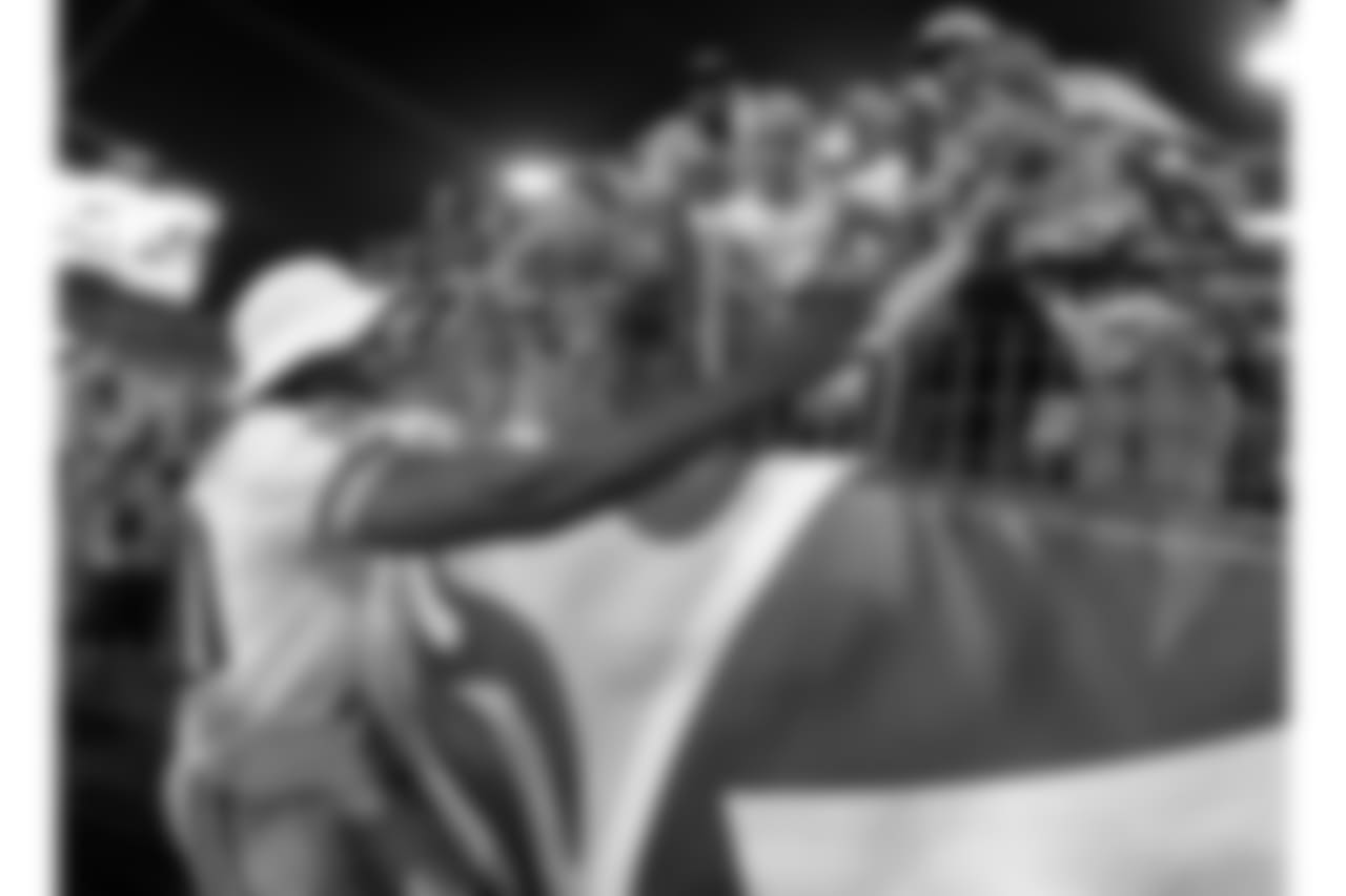 Washington Redskins quarterback Robert Griffin III shakes hands with fans following a 22-21 win over the Tennessee Titans in a preseason NFL football game on Thursday, Aug. 8, 2013, in Nashville, Tenn. (AP Photo/Wade Payne)