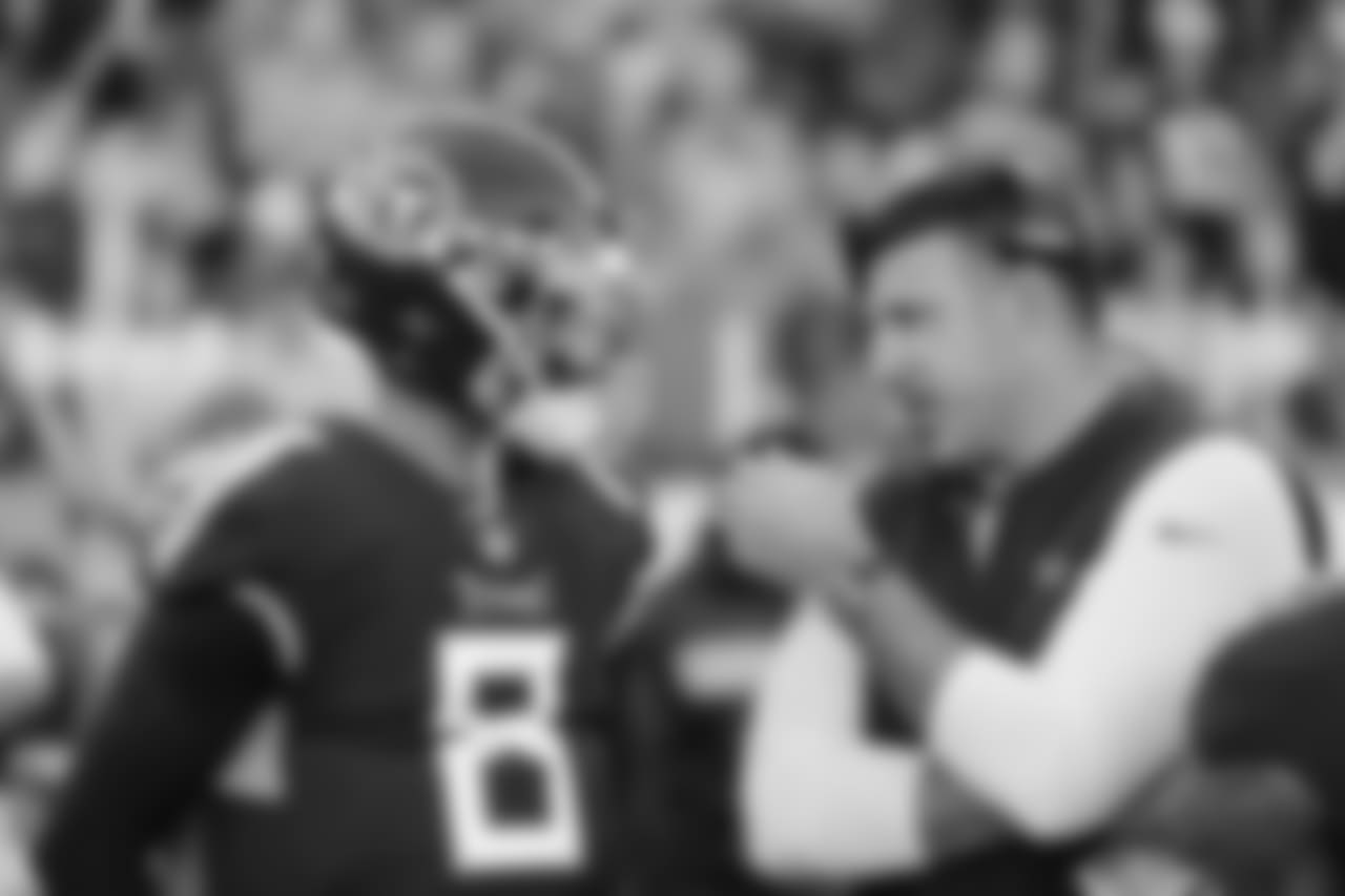 Tennessee Titans head coach Mike Vrabel, right, talks with quarterback Marcus Mariota (8) in the first half of an NFL football game against the New York Jets Sunday, Dec. 2, 2018, in Nashville, Tenn. (AP Photo/James Kenney)