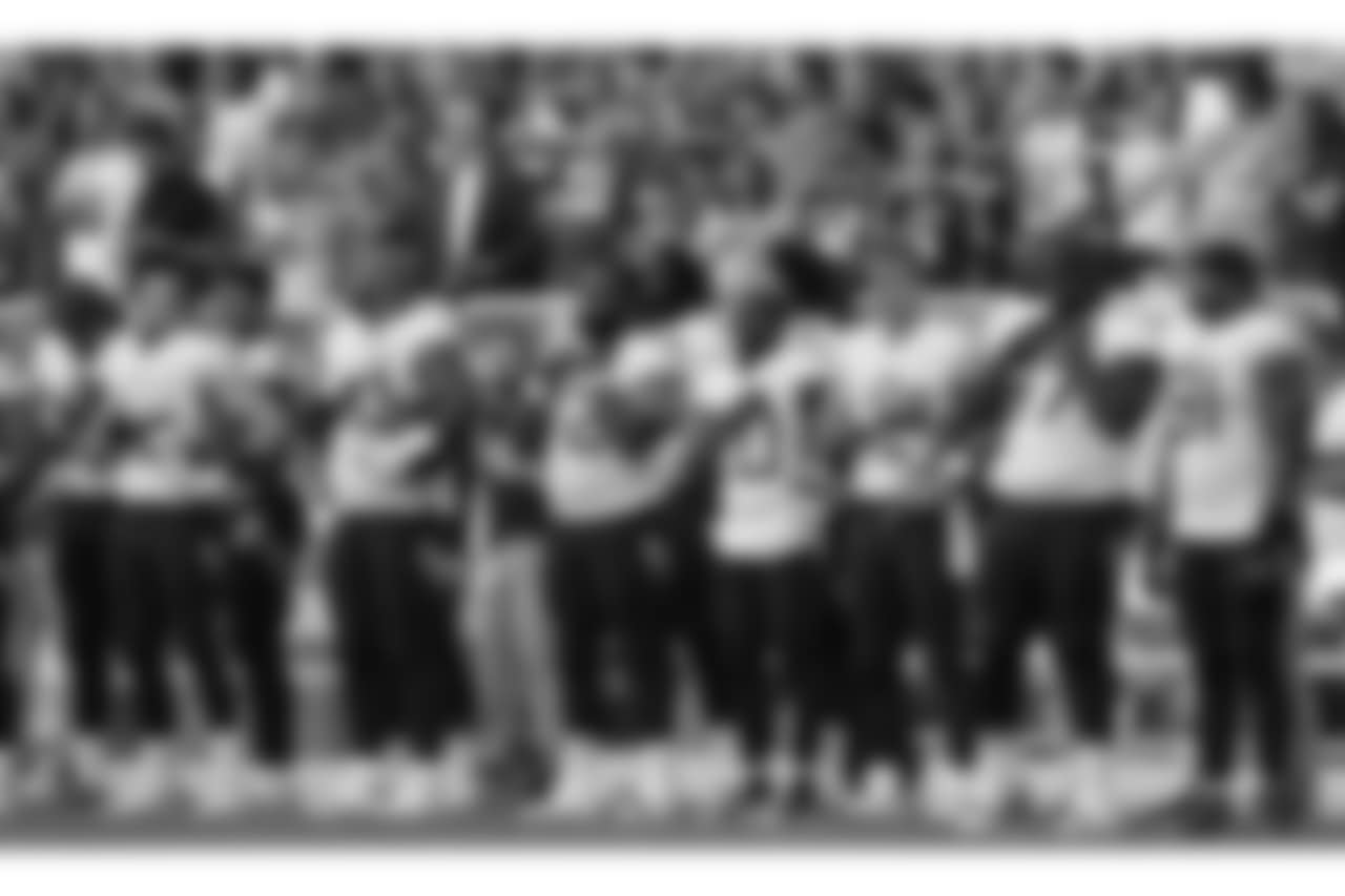 Tennessee Titans players line up for the national anthem before the first half of a preseason NFL football game against the Green Bay Packers Thursday, Aug. 9, 2018, in Green Bay, Wis. (AP Photo/Morry Gash)