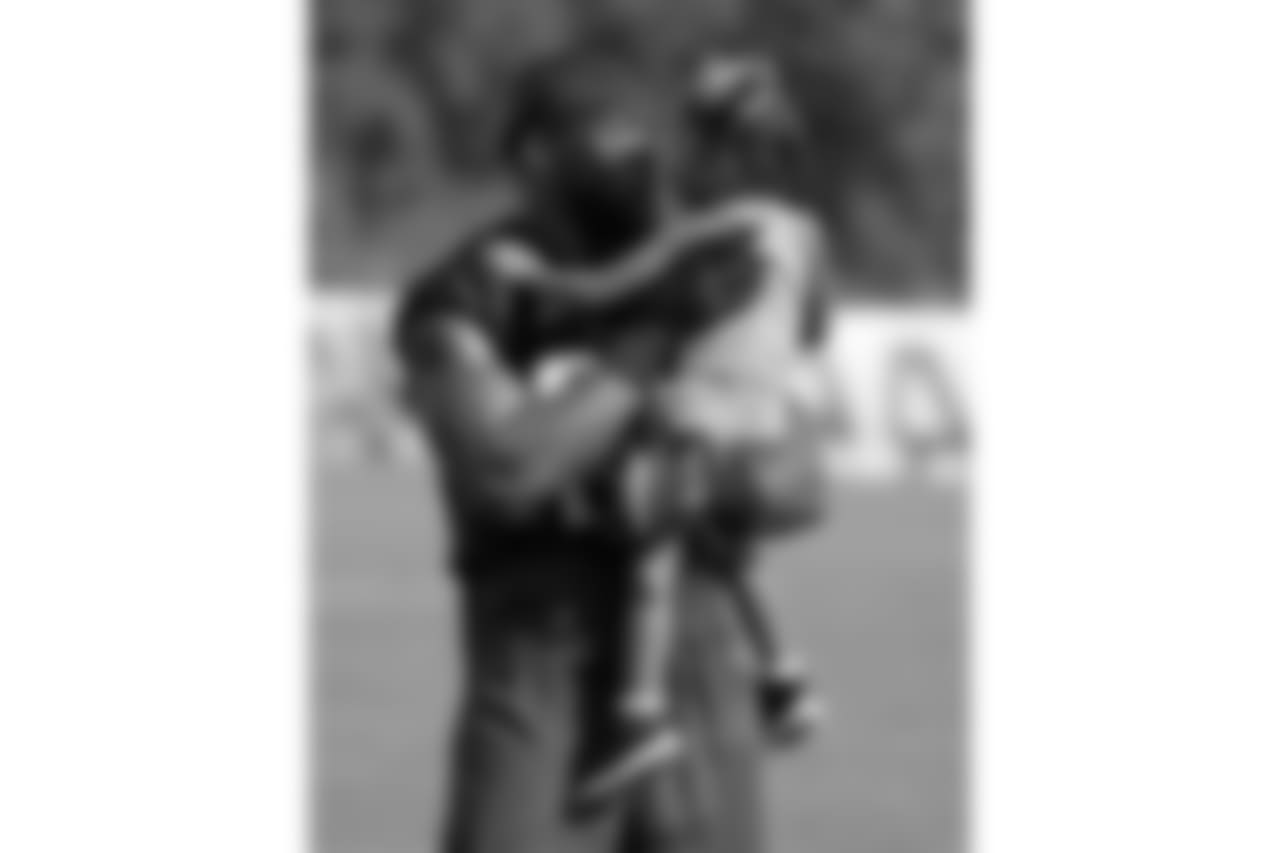 Tennessee Titans outside linebacker Brian Orakpo kisses his daughter, Brianna, 3, after NFL football training camp Saturday, July 30, 2016, in Nashville, Tenn. (AP Photo/Mark Humphrey)