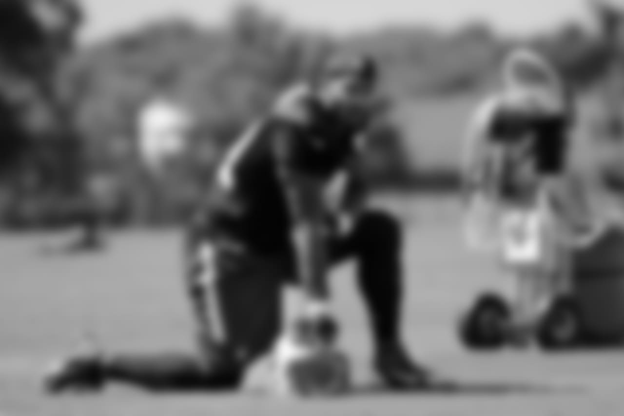 In this July 31, 2015 photo, Tennessee Titans linebacker Derrick Morgan takes a break during NFL football training camp in Nashville, Tenn. Morgan looked at other teams this offseason before the Titans convinced him to sign a new deal. Now he's paired opposite three-time Pro Bowler Brian Orakpo looking to improve off the best season of his career. (AP Photo/Mark Humphrey)
