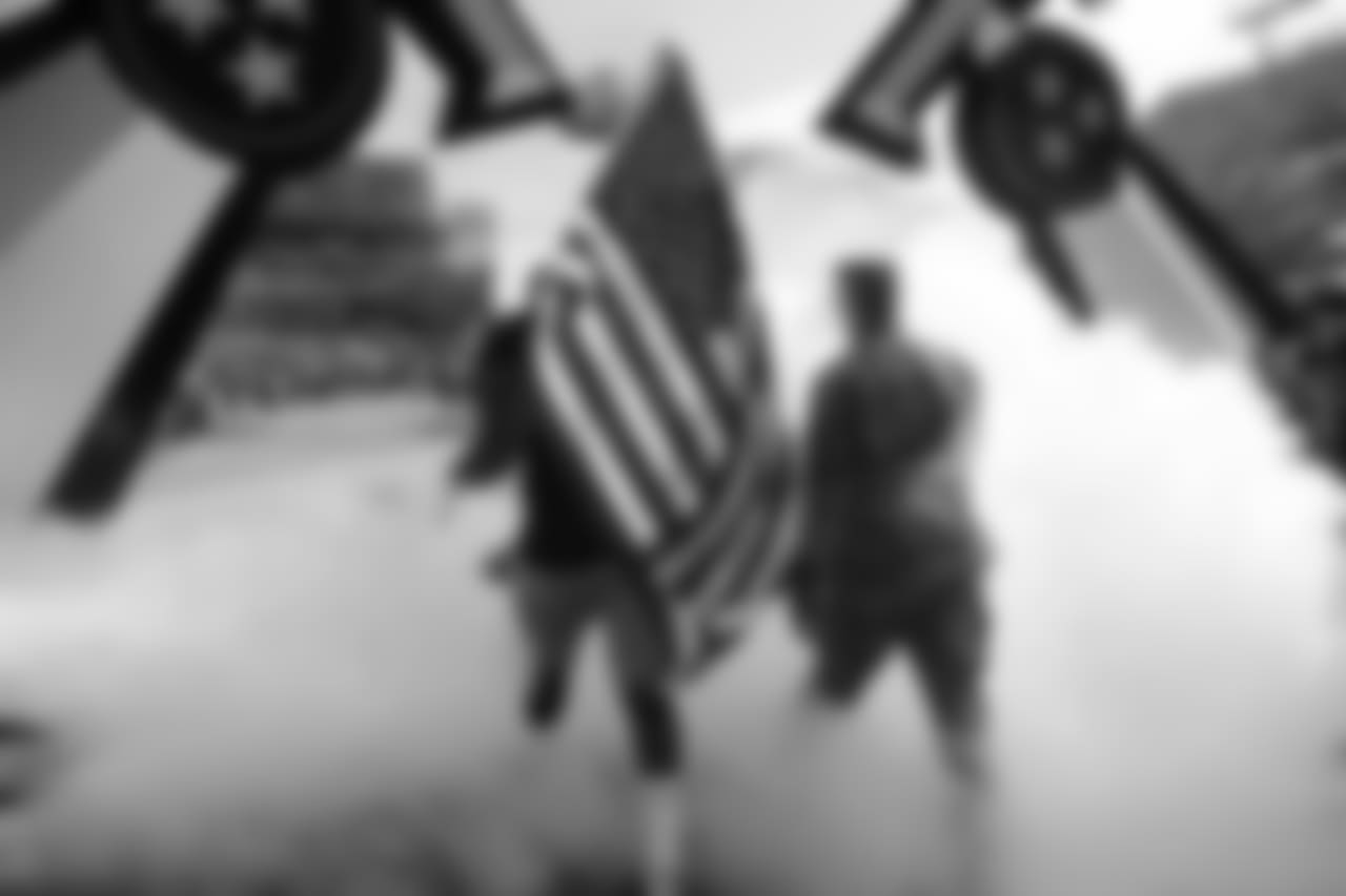 Tennessee Titans defensive end Jurrell Casey walks with a soldier and carries an American flag onto the field before an NFL football game between the Titans and the New England Patriots Sunday, Nov. 11, 2018, in Nashville, Tenn. (AP Photo/James Kenney)