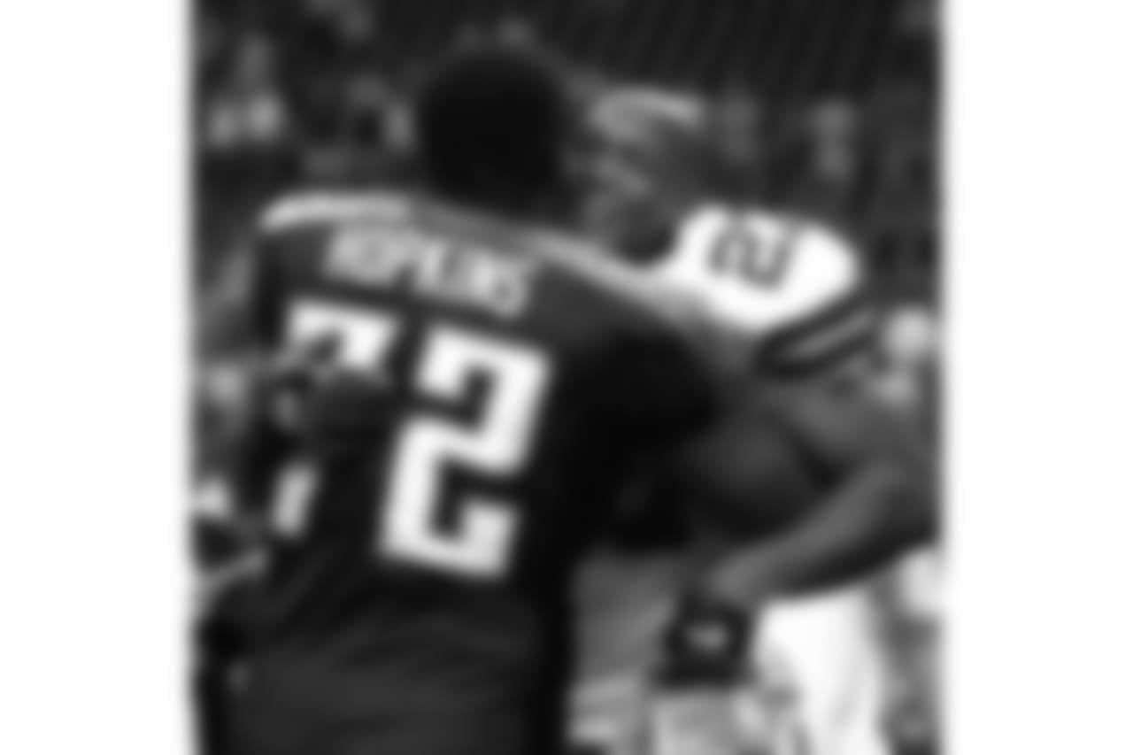 Dallas Cowboys running back Eddie George (27) hugs former teammate Tennessee Titans' Brad Hopkins (72) after their pre-season game in Irving, Texas, Monday, Aug. 30, 2004. The Cowboys won 20-17. (AP Photo/Tony Gutierrez)
