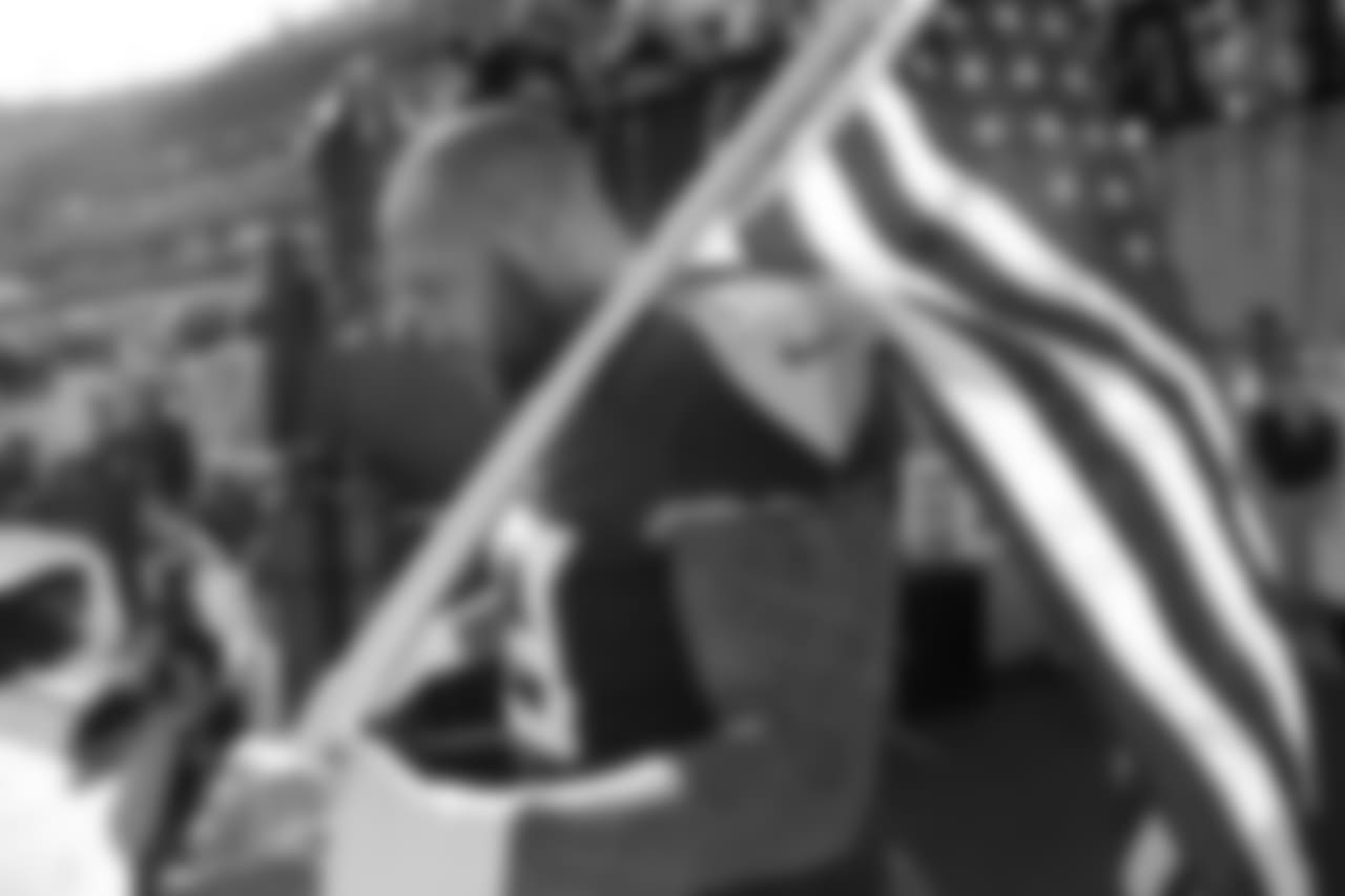 Tennessee Titans defensive end Jurrell Casey waits to carry an American flag onto the field before an NFL football game between the Titans and the New England Patriots Sunday, Nov. 11, 2018, in Nashville, Tenn. (AP Photo/James Kenney)