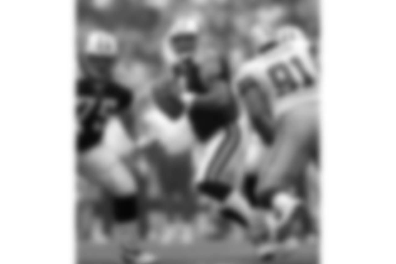 ** FILE ** Tennessee Titans quarterback Steve McNair (9) drops back to pass as teammate Benji Olson (75) looks to block Dallas Cowboys' Leonardo Carson (91) in Irving, Texas, Aug. 30, 2004. McNair said Friday, April 8, 2005 that he will return for his 11th season after an injured sternum plagued him for most of 2004. (AP Photo/Tony Gutierrez)