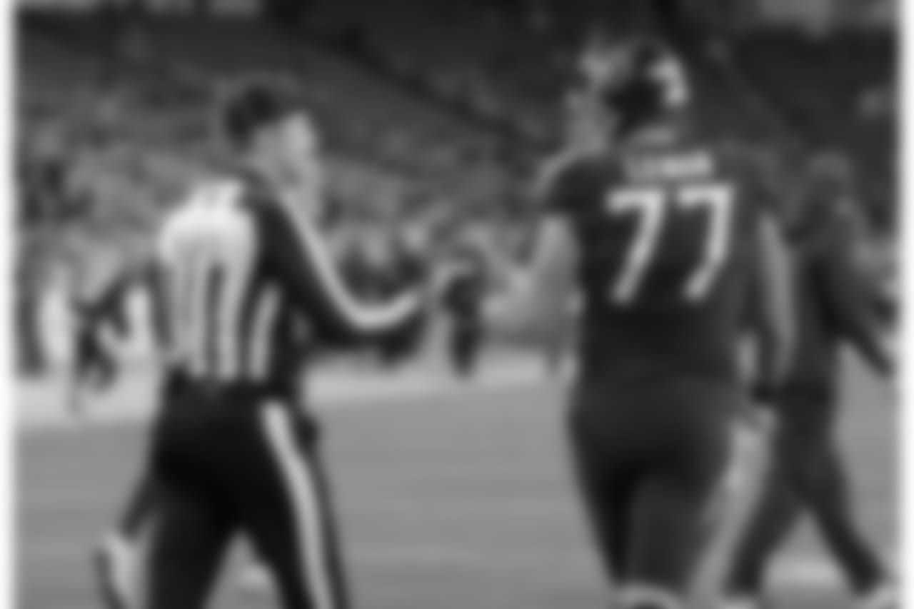 Umpire Mark Pellis (131) speaks with Tennessee Titans offensive tackle Taylor Lewan (77) before the first half of an NFL football game between the Tennessee Titans and the Jacksonville Jaguars, Thursday, Dec. 6, 2018, in Nashville, Tenn. (AP Photo/James Kenney)