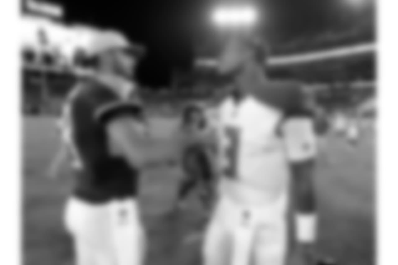 Tennessee Titans quarterback Marcus Mariota, left, meets with Tampa Bay Buccaneers quarterback Jameis Winston after a preseason NFL football game Saturday, Aug. 18, 2018, in Nashville, Tenn. The Buccaneers won 30-14. (AP Photo/Mark Zaleski)