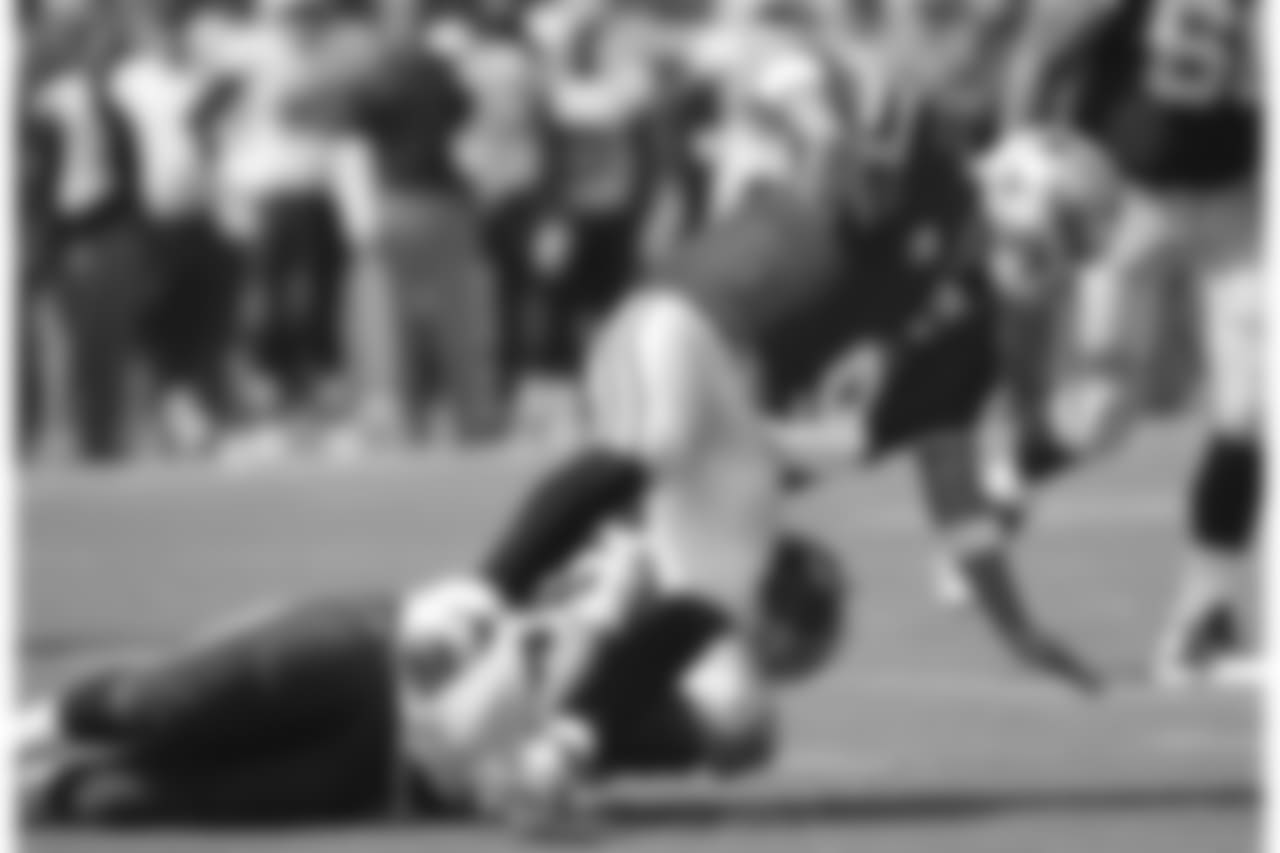 Dallas Cowboys quarterback Tony Romo (9) is sacked by Tennessee Titans defensive end Jurrell Casey (99) for a 12-yard loss in the first quarter of an NFL football game Sunday, Sept. 14, 2014, in Nashville, Tenn. (AP Photo/Mark Zaleski)