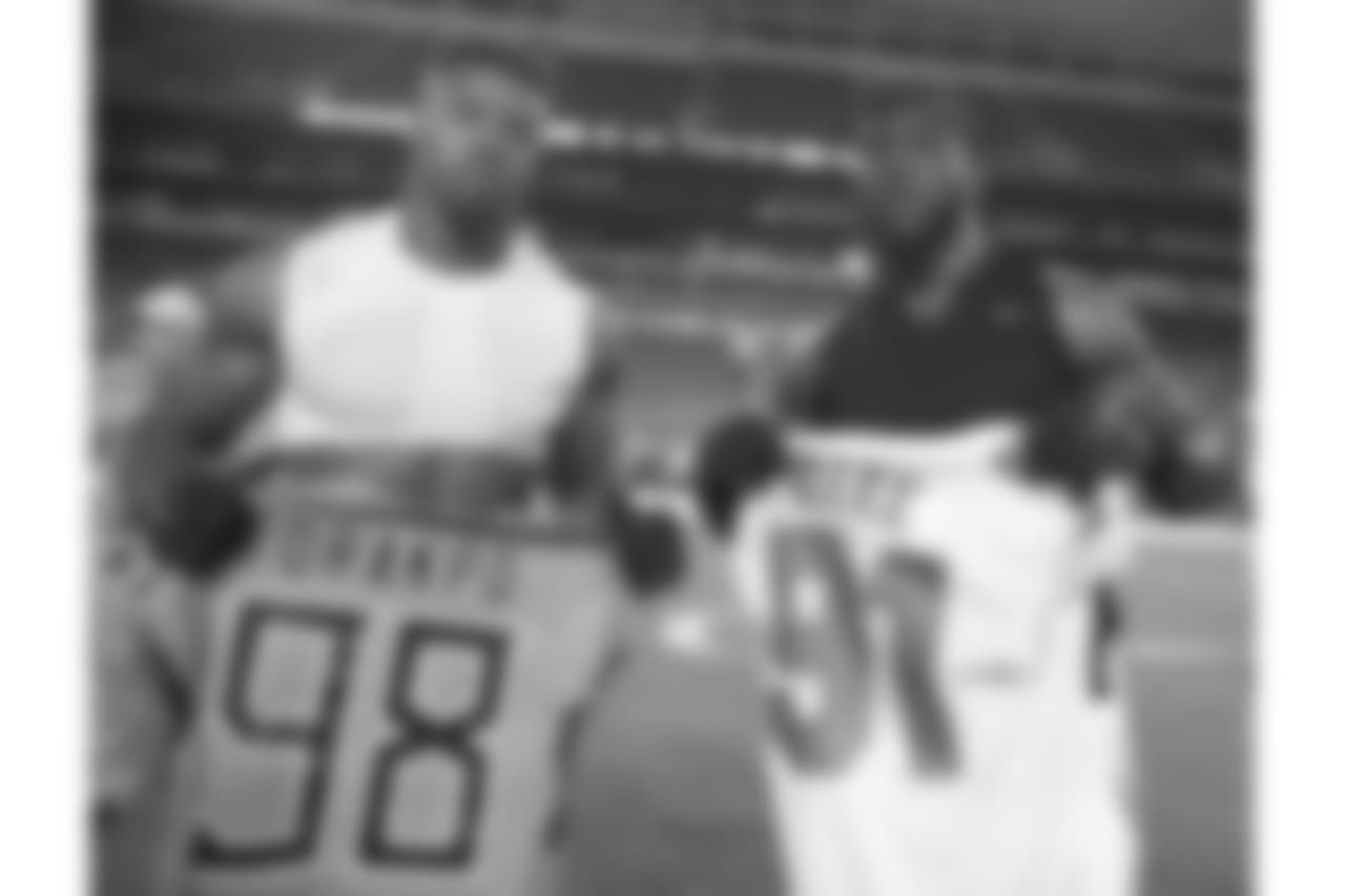 Tennessee Titans linebacker Brian Orakpo (98) and Miami Dolphins defensive end Cameron Wake (91) exchange jerseys, at the end of an NFL football game, Sunday, Sept. 9, 2018, in Miami Gardens, Fla. The Dolphins defeated the Titans 27-20. (AP Photo/Brynn Anderson)