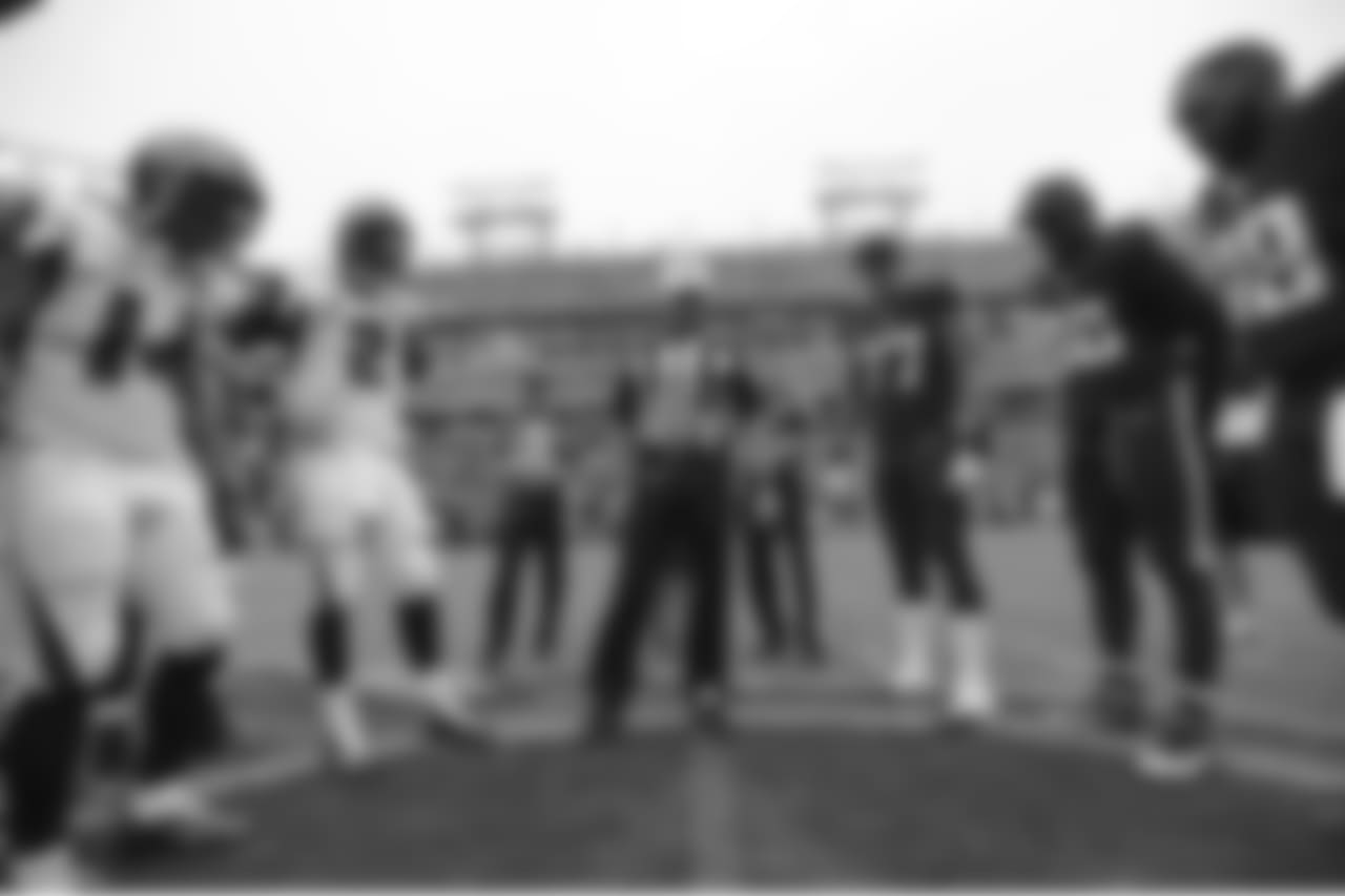 Atlanta Falcons wide receiver Eric Weems (14), quarterback Matt Ryan (2), Tennessee Titans tackle Taylor Lewan (77), linebacker Brian Orakpo (98) and defensive end Jurrell Casey (99) watch as referee Brad Allen tosses the coin before an NFL football game Sunday, Oct. 25, 2015, in Nashville, Tenn. (AP Photo/Mark Zaleski)