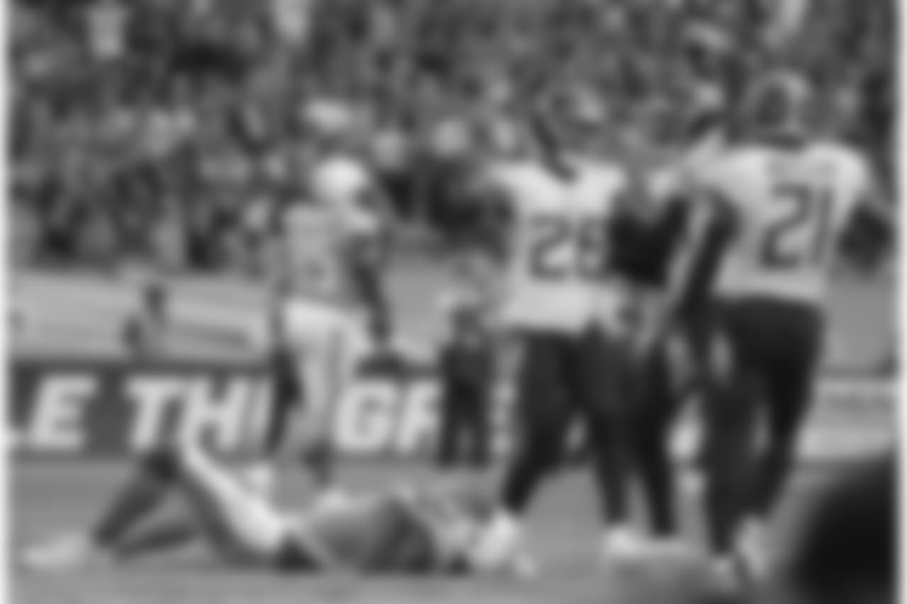 Los Angeles Chargers wide receiver Tyrell Williams (16), left, lies on the pitch after failing to catch the ball in the end zone during the second half of an NFL football game against Tennessee Titans at Wembley stadium in London, Sunday, Oct. 21, 2018. (AP Photo/Matt Dunham)