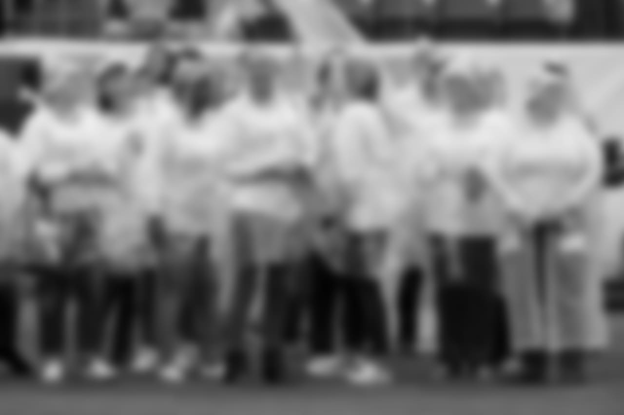 Breast cancer survivors stand on the field before an NFL football game between the Tennessee Titans and the Baltimore Ravens Sunday, Oct. 14, 2018, in Nashville, Tenn. (AP Photo/James Kenney)