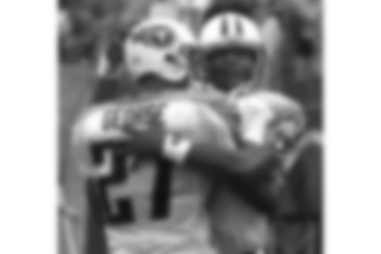 Tennessee Titans quarterback Steve McNair, right, congratulates running back Eddie George after George scored on a 7-yard touchdown run in the second quarter during the Titans' 28-14 win over the New York Giants on Sunday, Oct. 1, 2000 in Nashville, Tenn. The win for the Titans was their 10th straight home win, setting an NFL record for the most wins to christen a new stadium. The Titans began playing in Adelphia Coliseum in 1999. (AP Photo/Mark Humphrey)