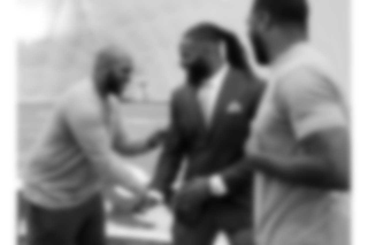 Former Tennessee Titans safety Michael Griffin, center, jokes with former teammates Jurrell Casey, left, and Wesley Woodyard, right, after Griffin signed a one-day contract with the team and then retired as a Titan Monday, May 7, 2018, in Nashville, Tenn. Griffin, a first-round pick by the Titans in 2007, played nine seasons for Tennessee. (AP Photo/Mark Humphrey)