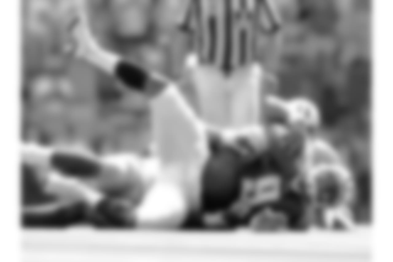 Tennessee Titans quarterback Steve McNair (9) grimmaces after being sacked by Dallas Cowboys defensive end Greg Ellis (98) for the second time in the fourth quarter Sunday, Sept. 15, 2002 in Irving, Texas. Dallas won, 21-13. (AP Photo/Steve Hamm)