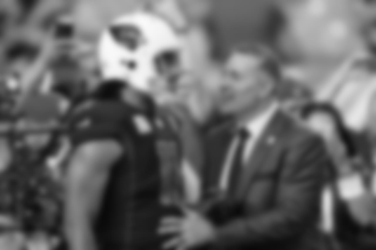 WR Larry Fitzgerald catches up with former Cardinals QB and current NFL Network commentator Kurt Warner before the game