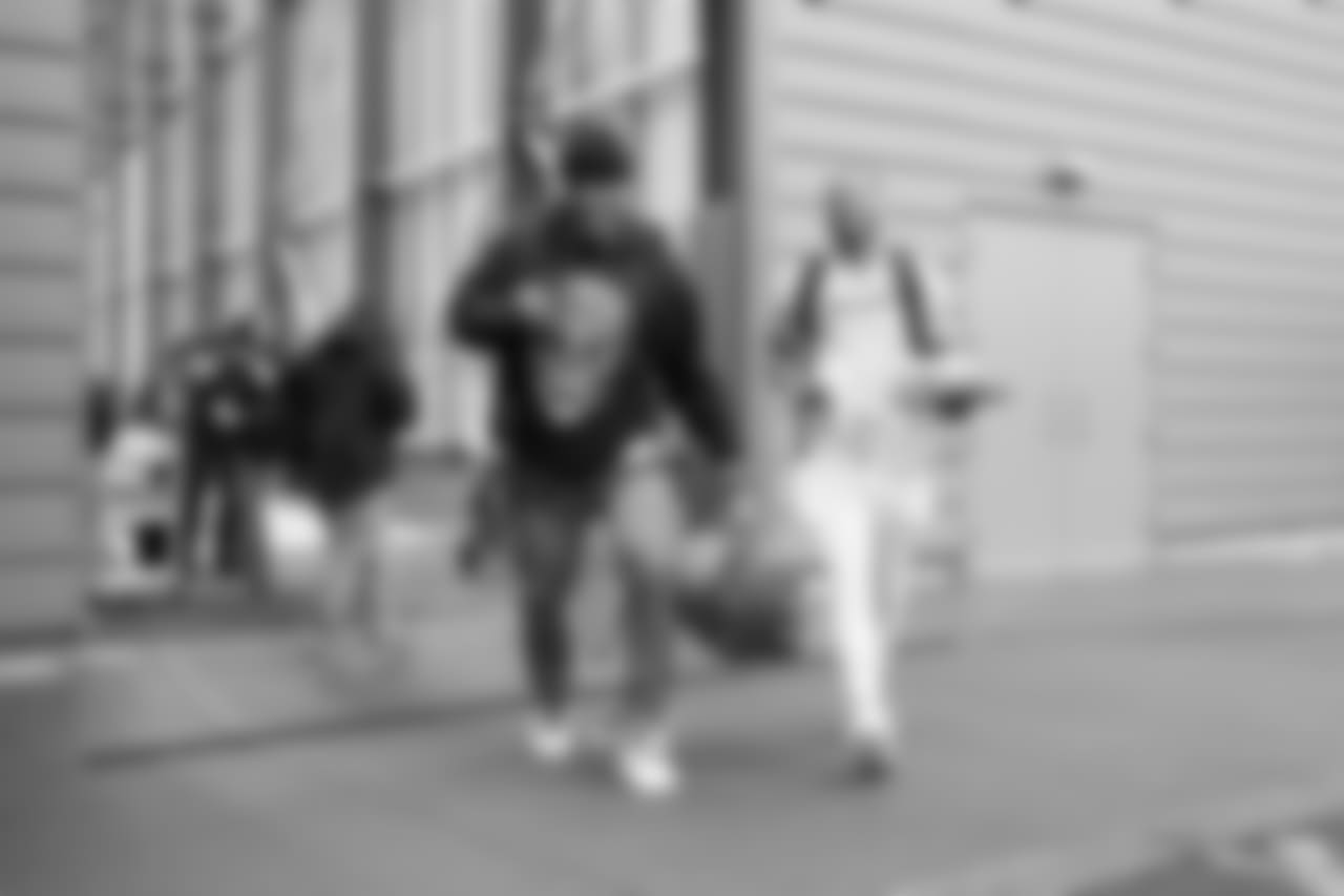 Frank Clark and Tyler Lockett walk from the team's indoor practice facility to the waiting buses.